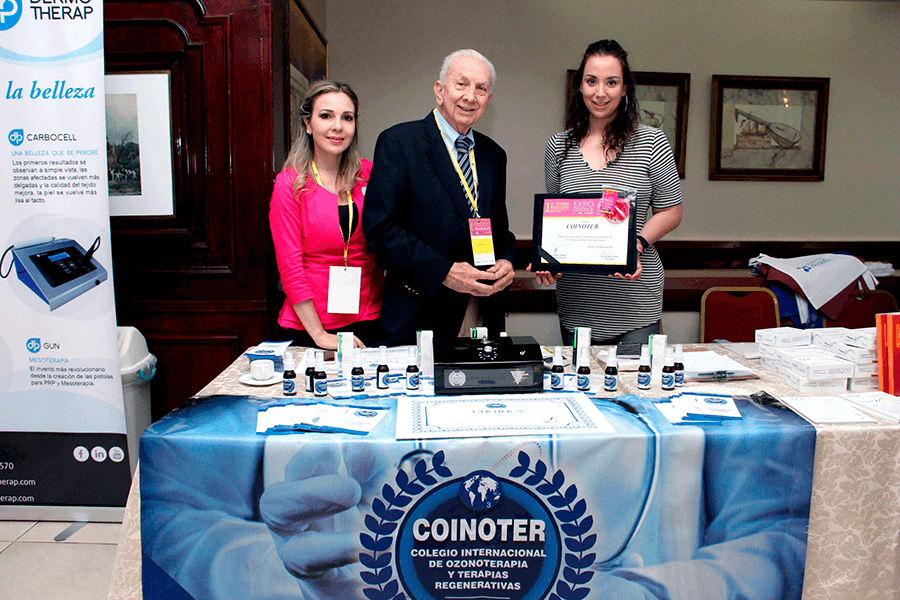 Entrega de reconocimiento COINOTER junto al stand con equipos de ozonoterapia